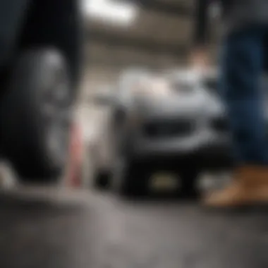 A mechanic inspecting the undercarriage of a used AWD car