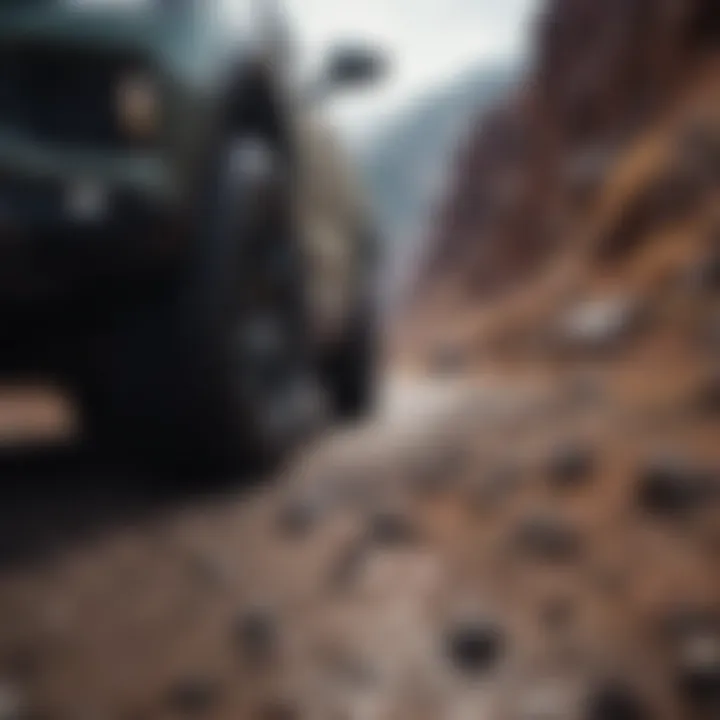 An automobile equipped with Dean Tires driving on a rugged terrain.