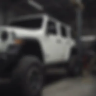 Mechanic performing installation of Dynatrac lift kit on a Jeep JL