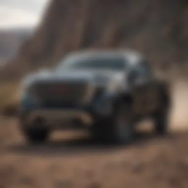 Powerful GMC Sierra Denali on rugged terrain, demonstrating its capability and performance.