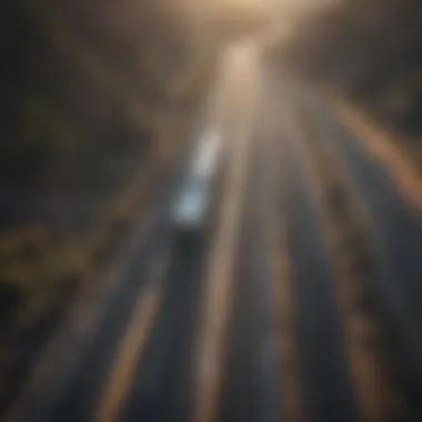 An aerial shot of a big rig navigating through a scenic highway, symbolizing the journey of transportation.